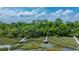 Stunning aerial shot of marsh with multiple docks, green trees, and waterway access at 130 Chadwick Dr Dr, Charleston, SC 29407