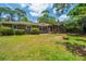 Back of brick home showing screened in porch and large windows overlooking the backyard at 130 Chadwick Dr Dr, Charleston, SC 29407