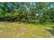 Expansive backyard features lush green grass, mature trees, and a fenced perimeter at 130 Chadwick Dr Dr, Charleston, SC 29407