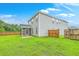 Exterior view of the home and backyard with a green lawn and wood fence at 1350 Wild Goose Trl, Summerville, SC 29483