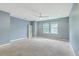 Spacious bedroom with neutral carpet, light blue walls, a ceiling fan, and a double window at 1350 Wild Goose Trl, Summerville, SC 29483