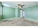 Empty bedroom with green walls, neutral carpet, and a ceiling fan and an open door at 1350 Wild Goose Trl, Summerville, SC 29483