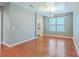 Open-concept dining room featuring hardwood floors, modern chandelier, and plenty of natural light at 1350 Wild Goose Trl, Summerville, SC 29483