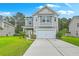 Charming two-story home with a well-manicured lawn and attached two-car garage at 1350 Wild Goose Trl, Summerville, SC 29483