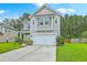 Inviting two-story home with a two-car garage, lush lawn, and established landscaping at 1350 Wild Goose Trl, Summerville, SC 29483