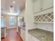 Well-lit kitchen with granite countertops, stainless steel appliances, white cabinets, and hardwood flooring at 1350 Wild Goose Trl, Summerville, SC 29483