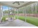View of the screened porch with a ceiling fan looking out onto the grassy backyard at 1350 Wild Goose Trl, Summerville, SC 29483