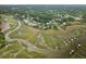 Aerial view features lush marshland and waterfront homes with boat docks at 1417 S Jetties Ct, Mount Pleasant, SC 29466