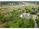 Aerial view of homes surrounded by lush trees and greenery in a waterfront community at 1417 S Jetties Ct, Mount Pleasant, SC 29466