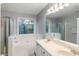 Bathroom with a soaking tub, double vanity sink and a view of the natural surroundings at 1417 S Jetties Ct, Mount Pleasant, SC 29466