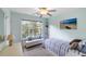 Bright bedroom featuring a window bench, beach-themed decor, and a ceiling fan for added comfort at 1417 S Jetties Ct, Mount Pleasant, SC 29466