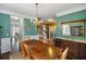 Elegant dining room featuring wood table, chandelier, mirror and views into the entry way and other living spaces at 1417 S Jetties Ct, Mount Pleasant, SC 29466