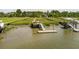 Marsh-side dock featuring a slide into the water, a dock, and a covered seating area with stairs at 1417 S Jetties Ct, Mount Pleasant, SC 29466