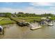 Marsh-side dock featuring a slide into the water, a dock, and a covered seating area with stairs at 1417 S Jetties Ct, Mount Pleasant, SC 29466