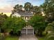 Charming two-story traditional home with a double porch and a two-car garage surrounded by lush greenery at 1417 S Jetties Ct, Mount Pleasant, SC 29466