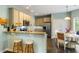 Open kitchen with bar seating, stainless appliances, granite counters, and dining area at 1417 S Jetties Ct, Mount Pleasant, SC 29466