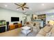 Comfortable living room with hardwood floors, ceiling fan and views into the kitchen area at 1417 S Jetties Ct, Mount Pleasant, SC 29466