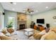 Comfortable living room with hardwood floors, ceiling fan and a stone fireplace and views outside at 1417 S Jetties Ct, Mount Pleasant, SC 29466