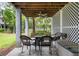 Covered patio with wicker furniture, ceiling fan, and lattice walls overlooking a private outdoor space at 1417 S Jetties Ct, Mount Pleasant, SC 29466