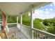 Relaxing front porch with columns and a porch swing overlooking lush greenery at 1417 S Jetties Ct, Mount Pleasant, SC 29466