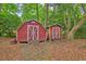 Two rustic backyard sheds surrounded by lush trees and natural foliage at 1430 Brian Rd, Charleston, SC 29407