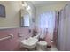Bathroom with pink tile, a new toilet, sink and a patterned shower curtain at 1430 Brian Rd, Charleston, SC 29407