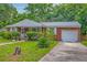 Charming single-story brick home with manicured lawn, attached garage and covered porch at 1430 Brian Rd, Charleston, SC 29407