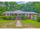 Charming red brick home with lush landscaping and inviting front porch at 1430 Brian Rd, Charleston, SC 29407