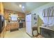 Traditional kitchen featuring knotty pine cabinets, laminate countertops, and black appliances at 1430 Brian Rd, Charleston, SC 29407