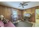 Relaxing living room with wood paneling, ceiling fan, and comfortable seating at 1430 Brian Rd, Charleston, SC 29407