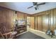 Wood-paneled living room with ceiling fan, TV, and closet at 1430 Brian Rd, Charleston, SC 29407
