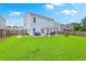 Large backyard featuring green grass, a patio with a grill, and a cozy fire pit for outdoor relaxation at 146 Chaste Tree Cir, Goose Creek, SC 29445