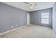 Bedroom featuring gray walls, a ceiling fan, one window, neutral carpet and white door at 146 Chaste Tree Cir, Goose Creek, SC 29445