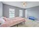 Bedroom with gray walls, a ceiling fan, two windows, and a bed with pink bedding at 146 Chaste Tree Cir, Goose Creek, SC 29445