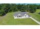Scenic aerial view of the home with its lush green lawn and surrounding wooded landscape at 148 Hidden Hills Rd, Cross, SC 29436
