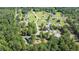 Wonderful aerial view of the neighborhood with lush green trees surrounding beautiful homes with large lawns at 148 Hidden Hills Rd, Cross, SC 29436