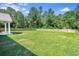 Lush, green backyard enclosed by a wooden fence, offering ample space at 148 Hidden Hills Rd, Cross, SC 29436