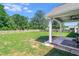 Expansive backyard featuring a well-maintained lawn and a partial covered patio at 148 Hidden Hills Rd, Cross, SC 29436