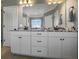 Bathroom with dual vanity, granite countertop, modern faucets, and white cabinetry at 148 Hidden Hills Rd, Cross, SC 29436