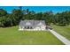 Charming home featuring a well-manicured lawn and inviting front porch with rocking chairs at 148 Hidden Hills Rd, Cross, SC 29436