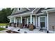 Cozy front porch with rocking chairs and seasonal décor, creating a welcoming entrance at 148 Hidden Hills Rd, Cross, SC 29436
