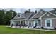 Inviting covered front porch with stone pillars and decorative accents, enhancing curb appeal at 148 Hidden Hills Rd, Cross, SC 29436