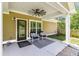 Covered patio area with seating, ceiling fan, and view of the backyard at 148 Hidden Hills Rd, Cross, SC 29436