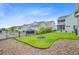 A manicured backyard features lush grass, stone landscaping, and a wrought iron fence surrounding the light-blue house at 1485 Bourne Xing, Mount Pleasant, SC 29466