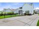The light-blue house features a fenced backyard with a paved patio, and green lawn at 1485 Bourne Xing, Mount Pleasant, SC 29466