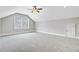A spacious carpeted bedroom with a window, ceiling fan, and a white door at 1485 Bourne Xing, Mount Pleasant, SC 29466
