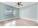 Light and airy bedroom features wood floors, a large window and light blue walls at 1485 Bourne Xing, Mount Pleasant, SC 29466