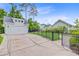 The long driveway leads to a two-car garage, showcasing a black wrought iron fence and professional landscaping at 1485 Bourne Xing, Mount Pleasant, SC 29466