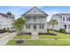 Charming two-story home with a double porch, complemented by lush landscaping and inviting curb appeal at 1485 Bourne Xing, Mount Pleasant, SC 29466