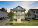 Charming two-story home with a double porch illuminated at dusk, surrounded by lush, manicured landscaping at 1485 Bourne Xing, Mount Pleasant, SC 29466